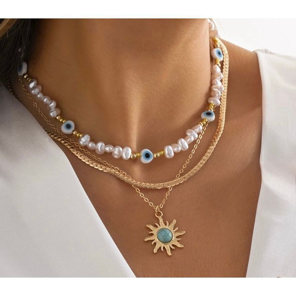 Multi strand layered necklace with evil eye faux freshwater pearls accented with